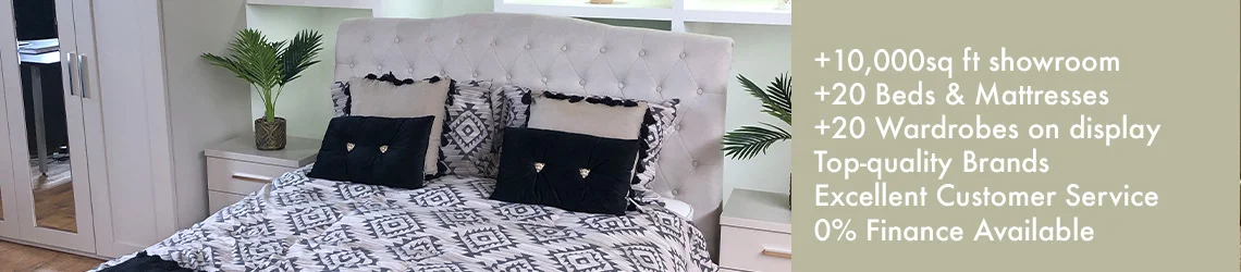 The image shows an upholstered double bed and details of the Pendle Village Bedroom Furniture Store showroom.