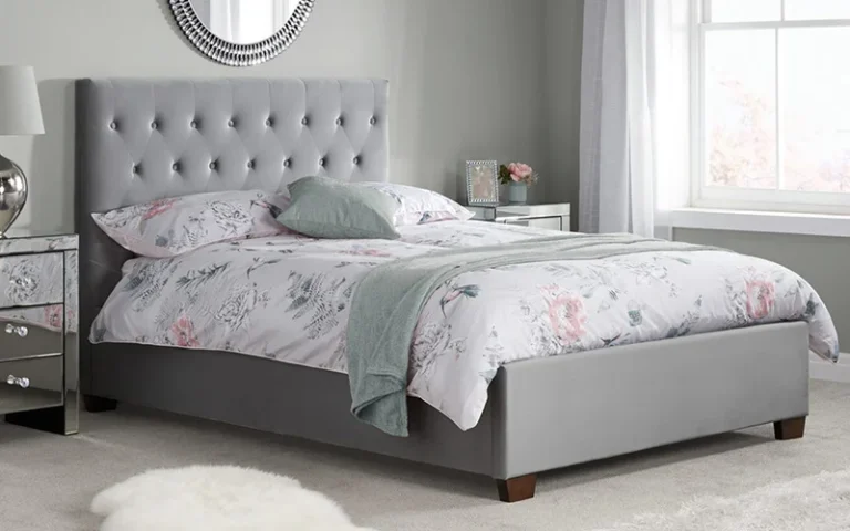 This image shows double size grey upholstered bed. Pendle Village Bed Shop, Near Burnley Lancashire, offers all size beds.
