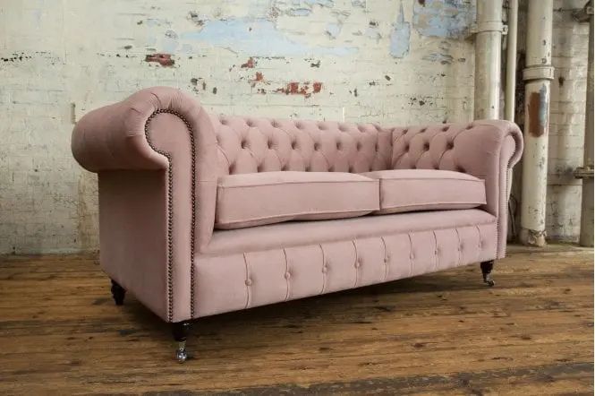 Side Angle With Three Legs View of Ashley Chesterfield Sofa In Light Pink - Styled in a Room