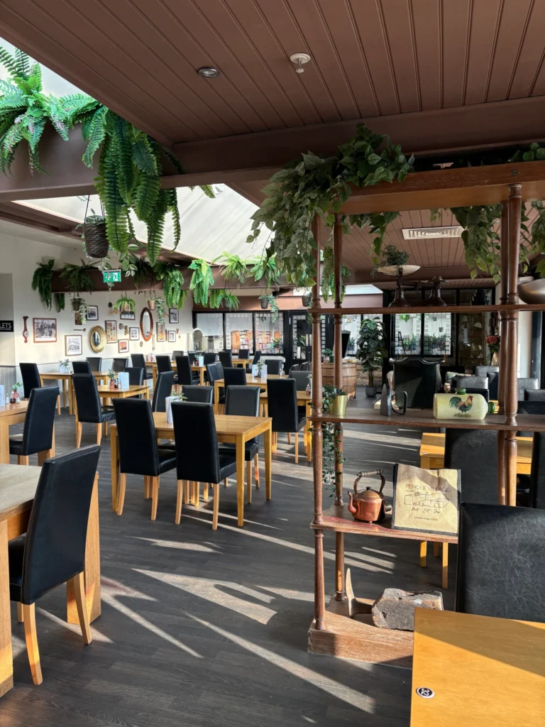 The Cafe Tearoom at Pendle Village near Burnley, offers a spacious family-friendly dining experience with lots of tables and seating areas.